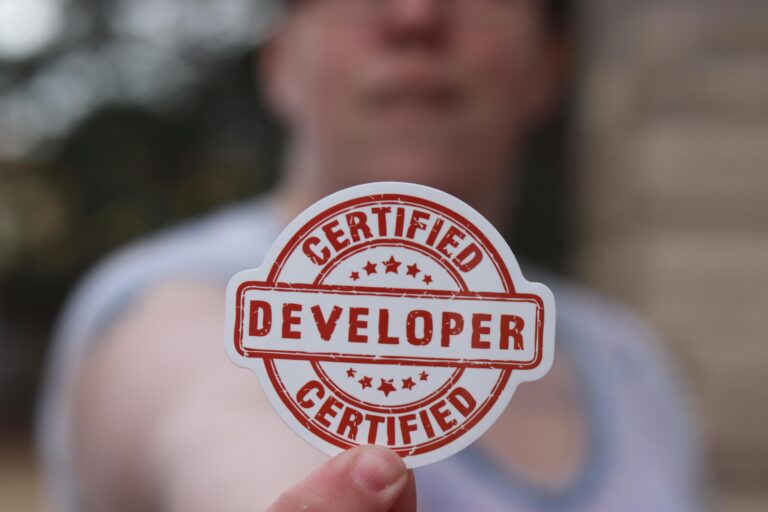 Close-up of a certified developer badge being held outdoors.